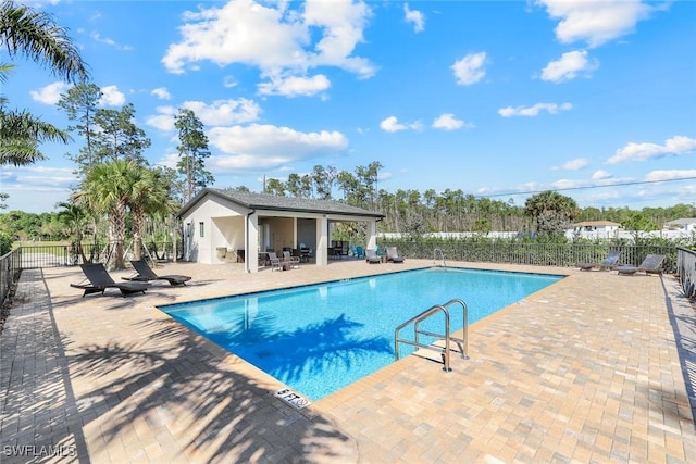 pool featuring a patio and fence