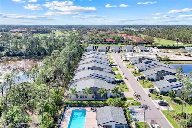 drone / aerial view featuring a residential view and a water view