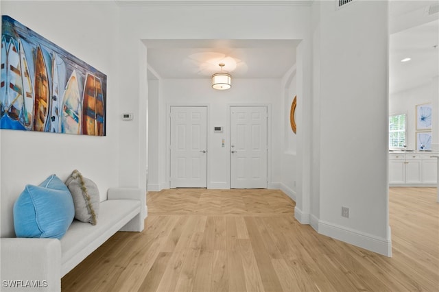 foyer entrance featuring light wood-style floors and baseboards