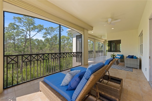 sunroom featuring a ceiling fan