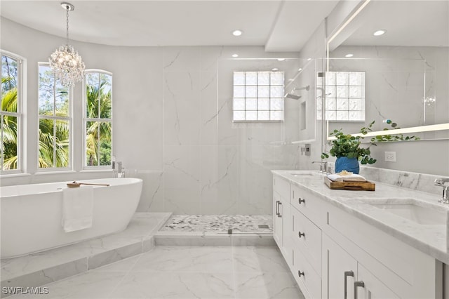 bathroom with plenty of natural light, marble finish floor, and a sink