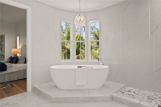 bathroom featuring a notable chandelier, marble finish floor, ensuite bath, a marble finish shower, and a freestanding bath