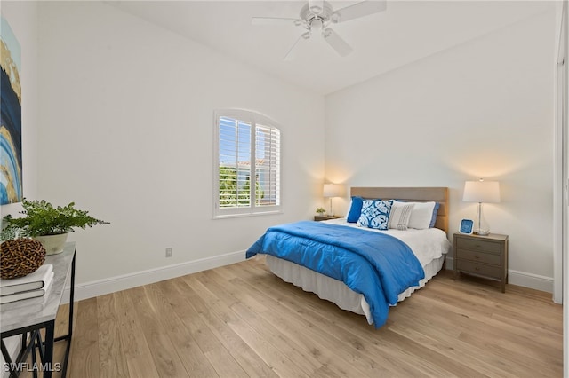 bedroom with baseboards, a ceiling fan, and light wood finished floors