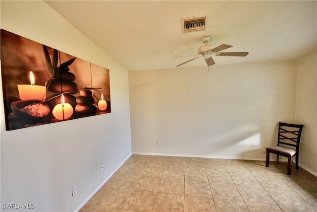 living area featuring light tile patterned floors, visible vents, baseboards, and ceiling fan