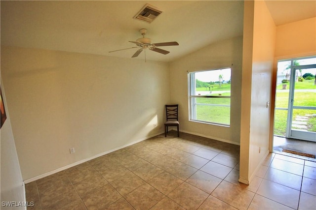 empty room featuring visible vents, a ceiling fan, tile patterned flooring, and vaulted ceiling