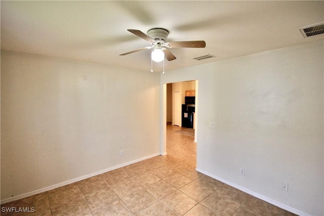 spare room with visible vents, baseboards, ceiling fan, and light tile patterned flooring