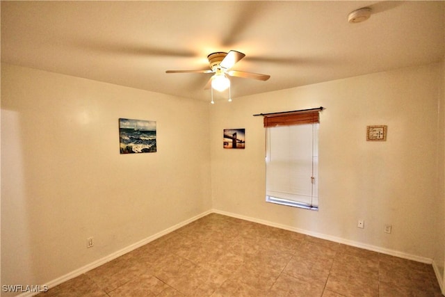 unfurnished room with baseboards and ceiling fan