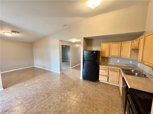 kitchen featuring light brown cabinetry, visible vents, black appliances, and light countertops