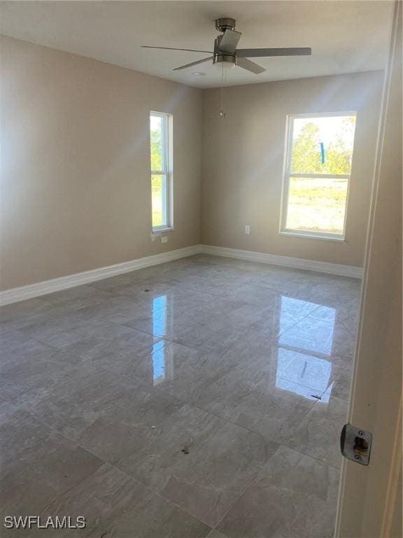 2910 28th St W, Lehigh Acres, FL 33971 - spare room with baseboards and ceiling fan