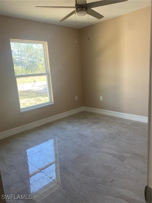 2910 28th St W, Lehigh Acres, FL 33971 - spare room with a ceiling fan and baseboards