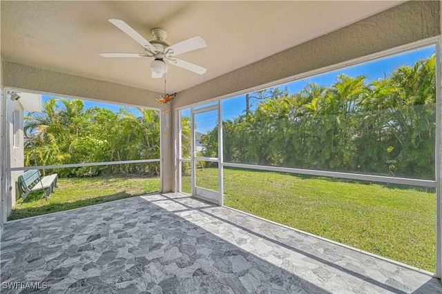 unfurnished sunroom with a ceiling fan