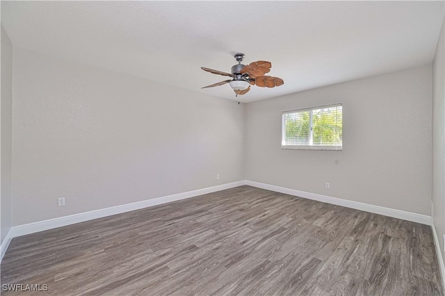 spare room with wood finished floors, baseboards, and ceiling fan