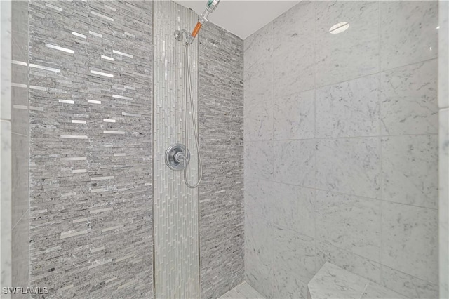 bathroom with a tile shower