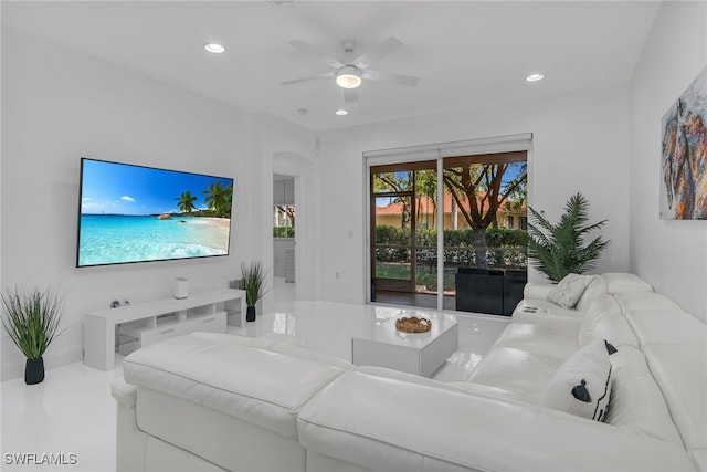 living area featuring arched walkways, recessed lighting, and ceiling fan