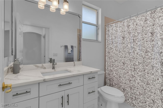 bathroom with toilet, vanity, and a shower with shower curtain