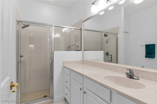 bathroom featuring vanity and a shower stall