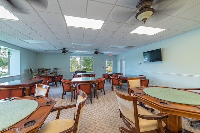 interior space featuring a drop ceiling and ceiling fan