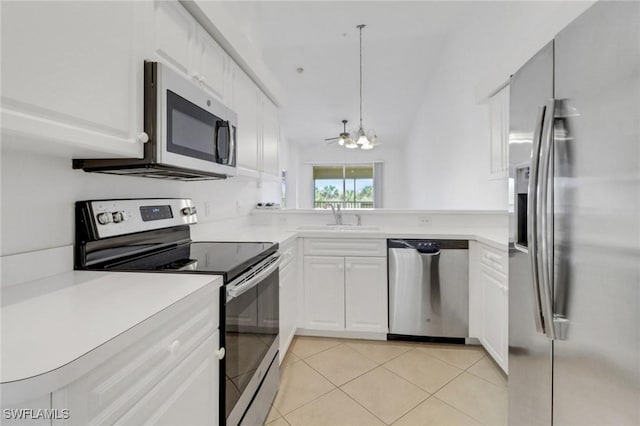 kitchen with a sink, white cabinetry, appliances with stainless steel finishes, light tile patterned flooring, and light countertops