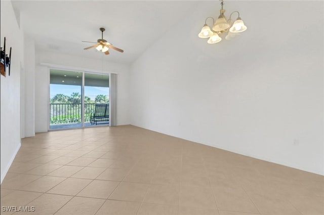 spare room featuring vaulted ceiling, light tile patterned floors, and ceiling fan with notable chandelier