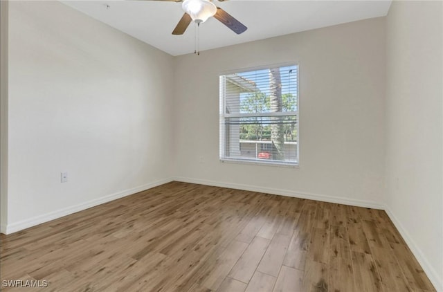 unfurnished room featuring baseboards, light wood-style flooring, and a ceiling fan