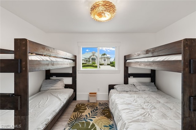 bedroom featuring baseboards and wood finished floors