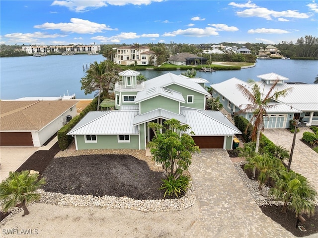 drone / aerial view featuring a residential view and a water view