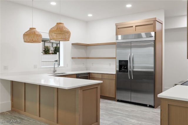 kitchen featuring open shelves, built in refrigerator, recessed lighting, a peninsula, and a sink