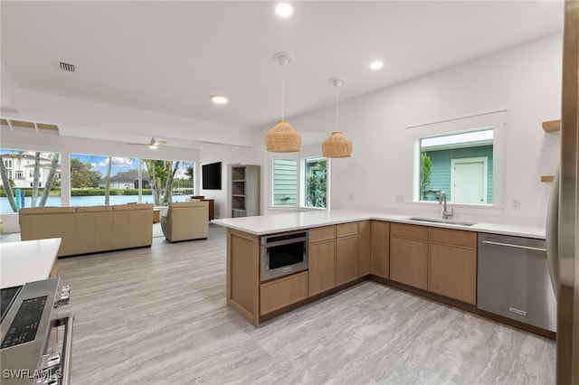 kitchen featuring visible vents, appliances with stainless steel finishes, light countertops, and a sink