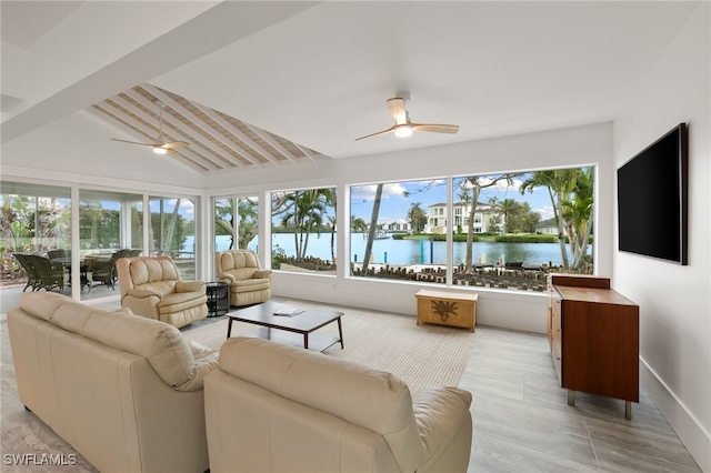 living room with baseboards, vaulted ceiling with beams, and a ceiling fan