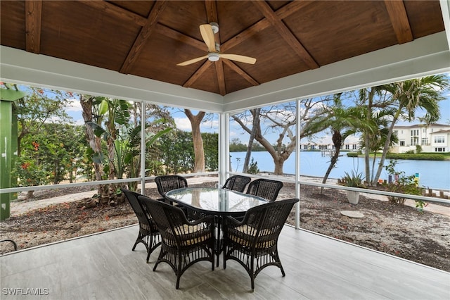 sunroom / solarium featuring vaulted ceiling, wooden ceiling, ceiling fan, and a water view