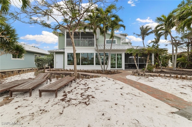 back of house featuring a sunroom