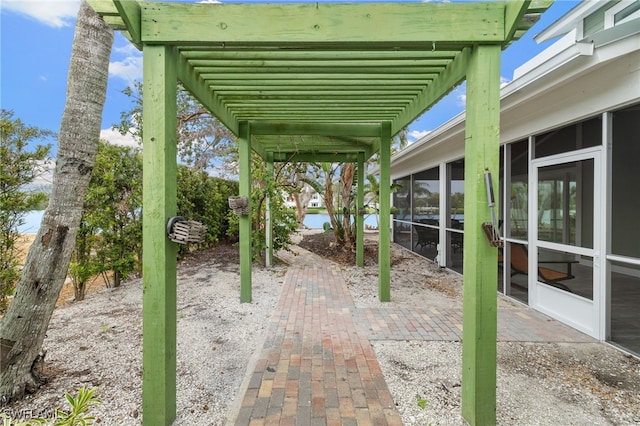 view of patio / terrace with a pergola and a sunroom