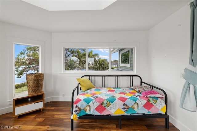 bedroom with baseboards and wood finished floors