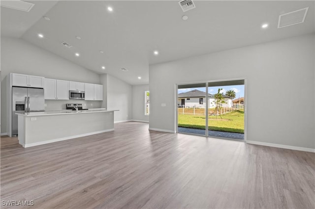 unfurnished living room with visible vents, recessed lighting, baseboards, and light wood-style floors