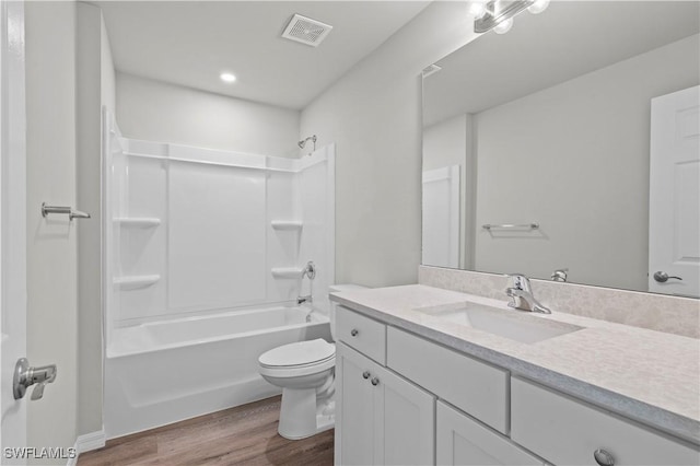 full bath with vanity, wood finished floors, visible vents, shower / tub combination, and toilet