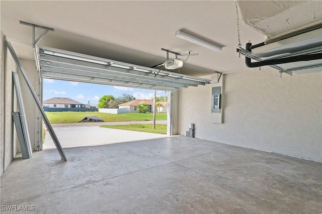 garage with electric panel and a garage door opener