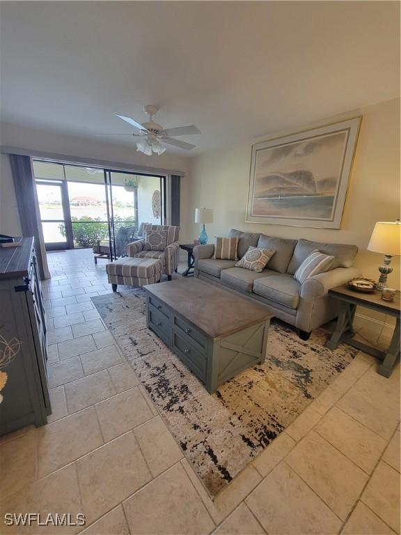 living room featuring light tile patterned flooring and a ceiling fan