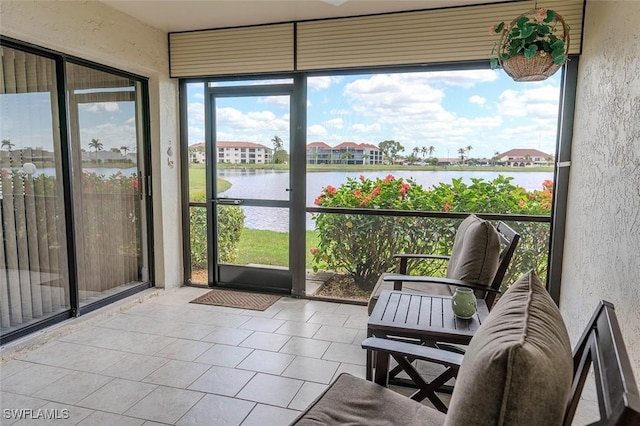 sunroom featuring a water view