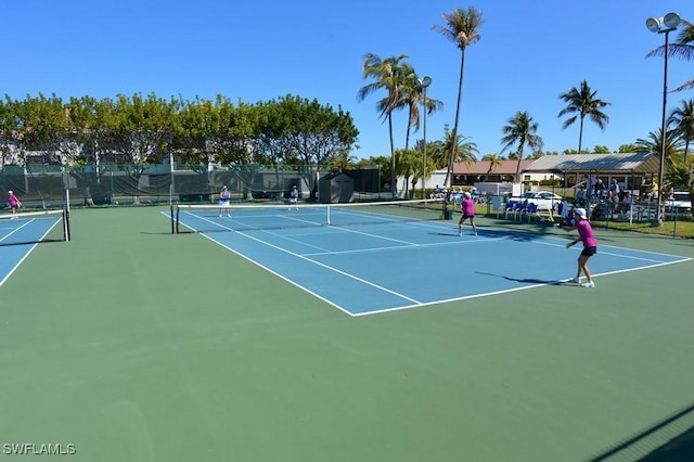 view of tennis court with fence