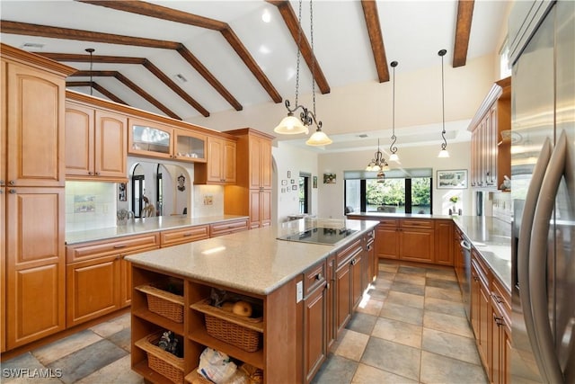 kitchen featuring a kitchen island, open shelves, a peninsula, stainless steel refrigerator, and black electric stovetop