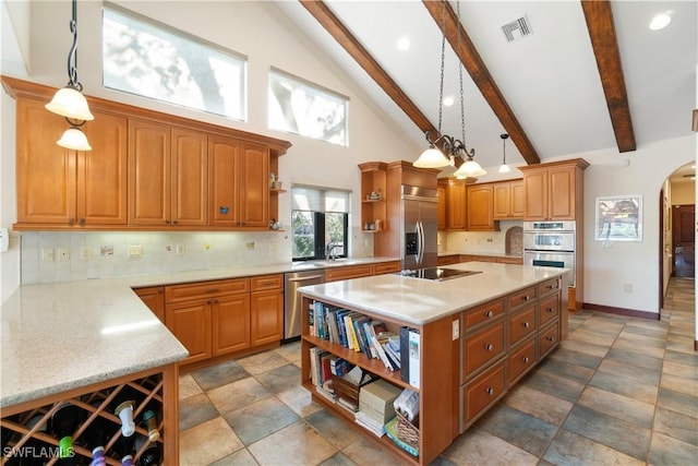 kitchen with visible vents, open shelves, arched walkways, a sink, and stainless steel appliances