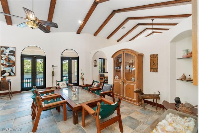 dining space featuring baseboards, ceiling fan, beam ceiling, french doors, and high vaulted ceiling