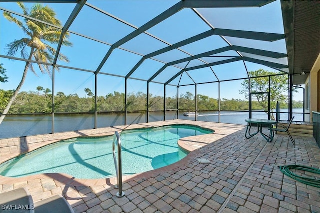 outdoor pool with a water view, a lanai, and a patio area