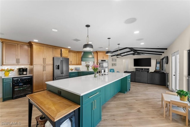 kitchen with wine cooler, light countertops, decorative backsplash, appliances with stainless steel finishes, and light wood-style floors