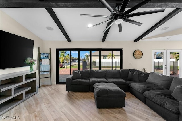 living area with a wealth of natural light, french doors, lofted ceiling with beams, and light wood-style floors