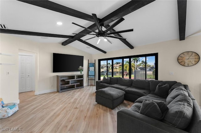 living room featuring visible vents, light wood-style floors, baseboards, ceiling fan, and vaulted ceiling with beams