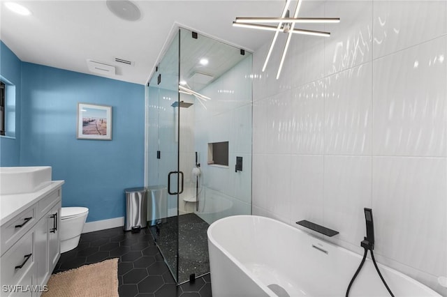 bathroom with vanity, a soaking tub, a shower stall, tile patterned floors, and toilet