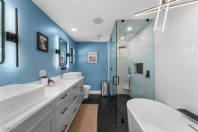 bathroom featuring a sink, a freestanding tub, a shower stall, and tile patterned flooring