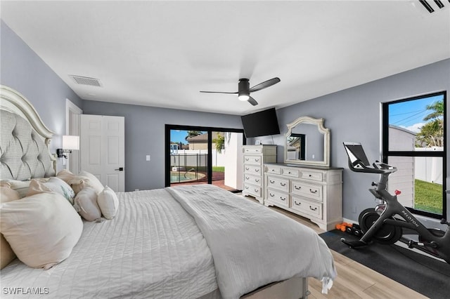 bedroom featuring ceiling fan, visible vents, wood finished floors, and access to exterior