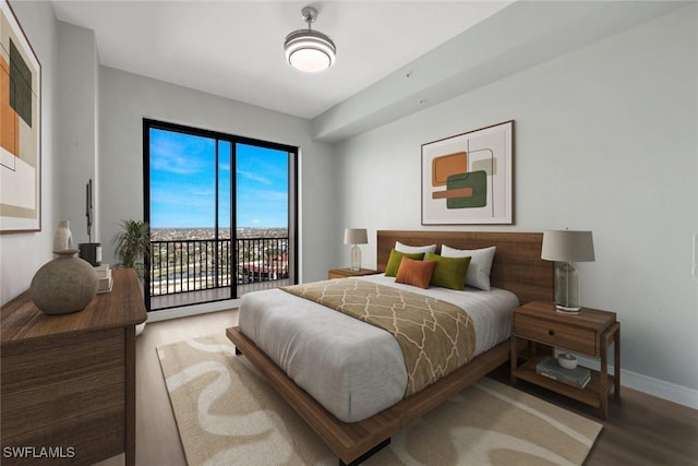 bedroom featuring wood finished floors, baseboards, and access to outside